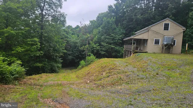 a front view of a house with yard and green space