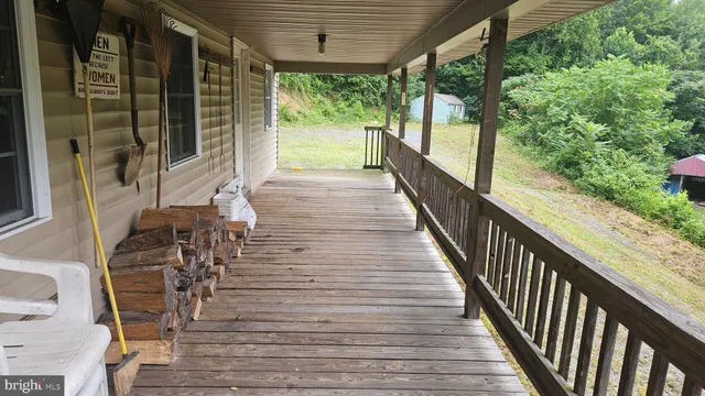 a view of balcony with wooden floor and fence