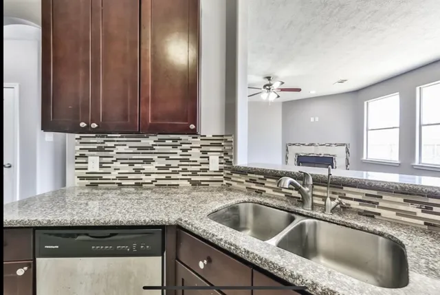 a stove top oven sitting inside of a kitchen