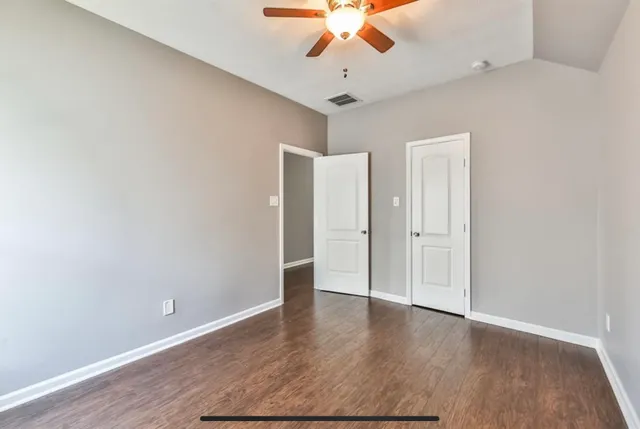 a bathroom with a granite countertop sink toilet a mirror and shower