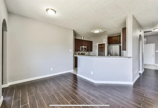 a view of a kitchen cabinets and wooden floor