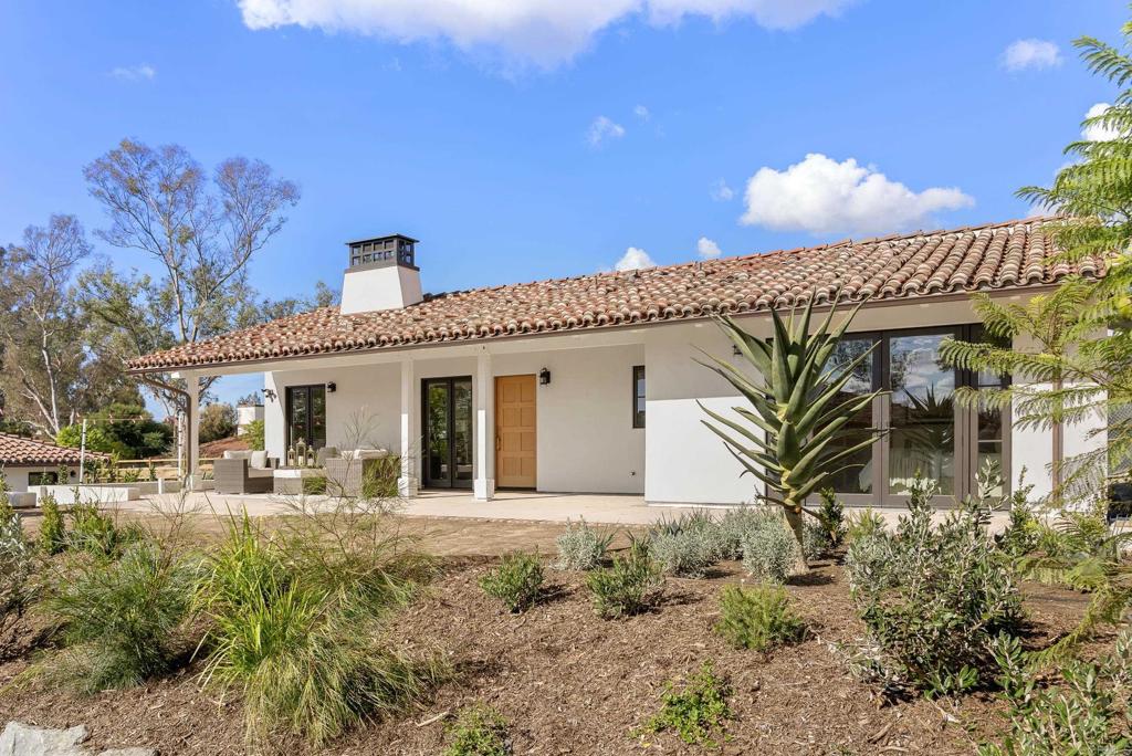 5929 Linea Del Cielo, Unit JACARANDA Rancho Santa Fe, CA 92067 - Photo 12 of 16 a front view of a house with garden