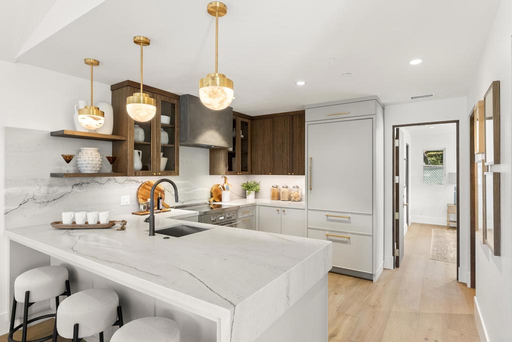 5929 Linea Del Cielo, Unit JACARANDA Rancho Santa Fe, CA 92067 - Photo 4 of 16 a kitchen with a refrigerator a sink and a stove