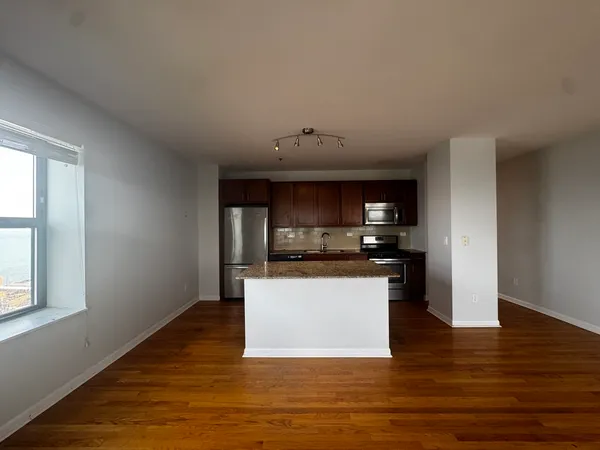 a kitchen with stainless steel appliances granite countertop a sink and cabinets