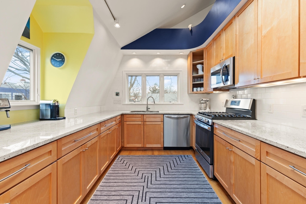36 Gorham Street, Unit 3 Cambridge, MA 02138 - Photo 10 of 31 a kitchen with stainless steel appliances granite countertop a sink and cabinets