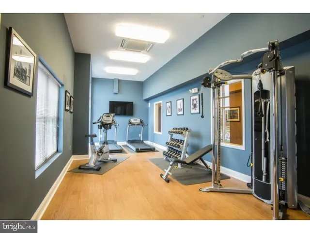 a living room with furniture a flat screen tv and a table