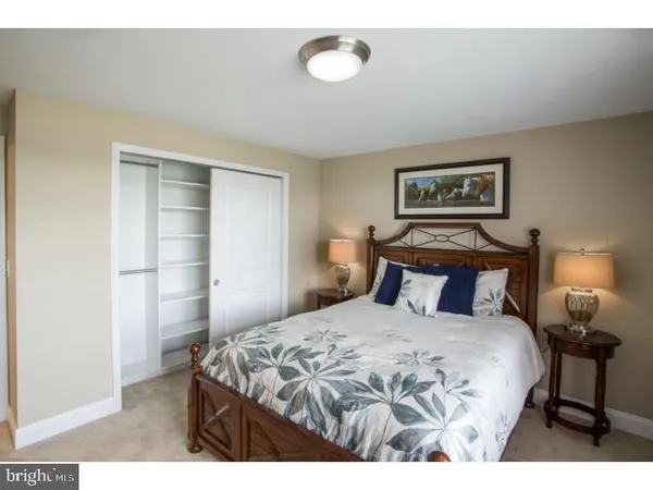 a bedroom with a bed and a lamp