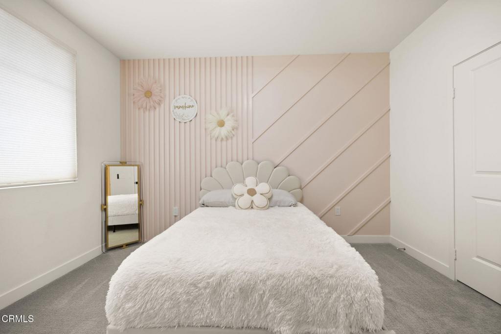 2850 Wagon Wheel Road, Unit 302 Oxnard, CA 93036 - Photo 18 of 50 a bedroom with a bed and a night stand