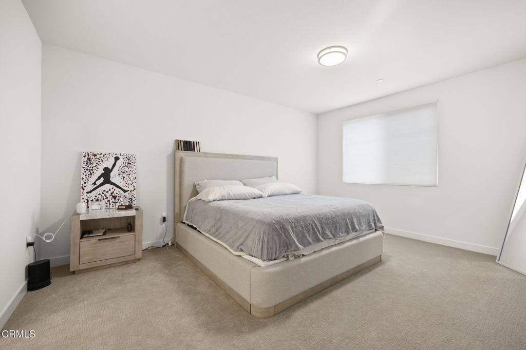 2850 Wagon Wheel Road, Unit 302 Oxnard, CA 93036 - Photo 23 of 50 a bed room with a bed and a chair