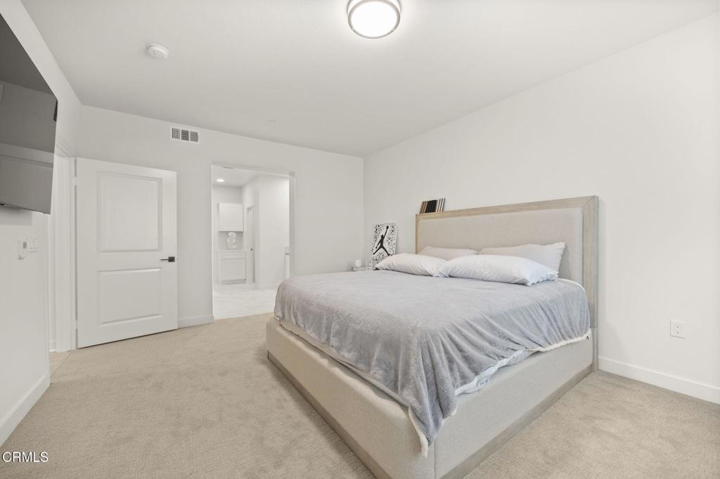 2850 Wagon Wheel Road, Unit 302 Oxnard, CA 93036 - Photo 24 of 50 a bed room with a bed and a night stand