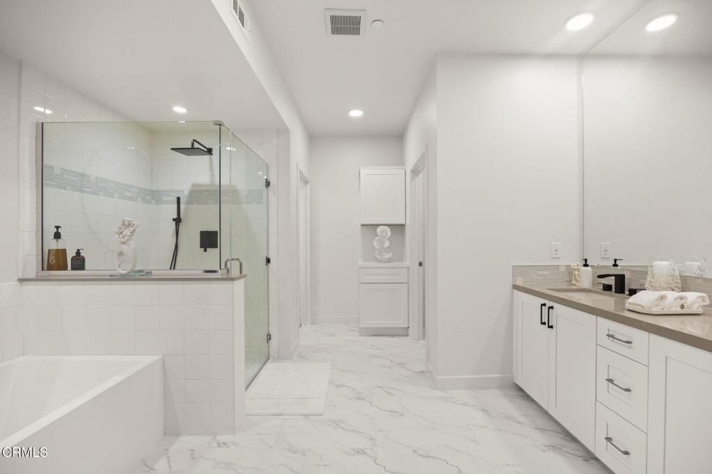 2850 Wagon Wheel Road, Unit 302 Oxnard, CA 93036 - Photo 25 of 50 a bathroom with a double vanity sink a mirror and a shower
