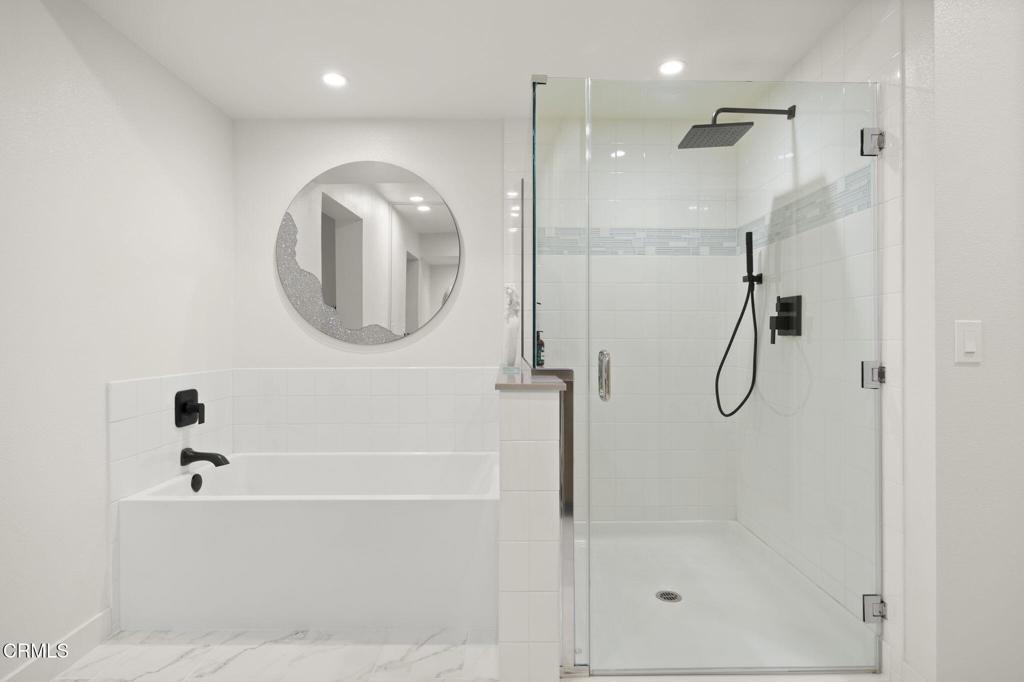 2850 Wagon Wheel Road, Unit 302 Oxnard, CA 93036 - Photo 28 of 50 a bathroom with a shower and a bath tub