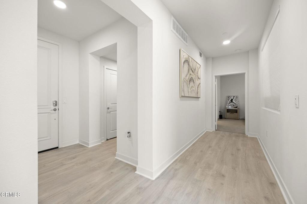 2850 Wagon Wheel Road, Unit 302 Oxnard, CA 93036 - Photo 33 of 50 a view of a hallway with wooden floor and closet