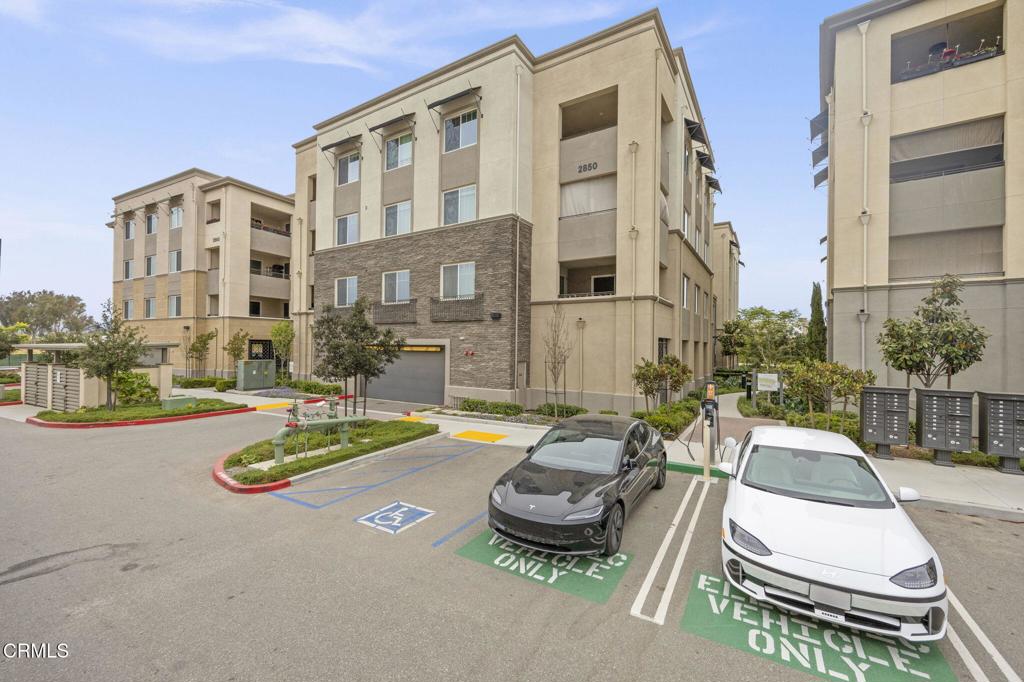 2850 Wagon Wheel Road, Unit 302 Oxnard, CA 93036 - Photo 43 of 50 a view of a patio with swimming pool and table or chairs