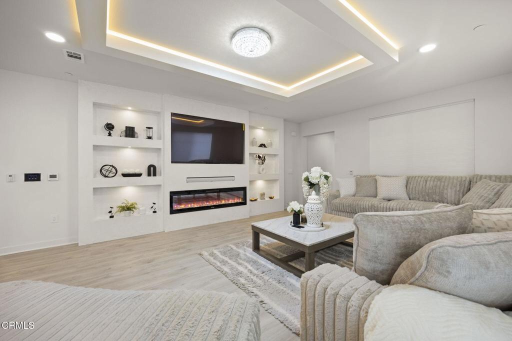 2850 Wagon Wheel Road, Unit 302 Oxnard, CA 93036 - Photo 5 of 50 a living room with furniture and a flat screen tv