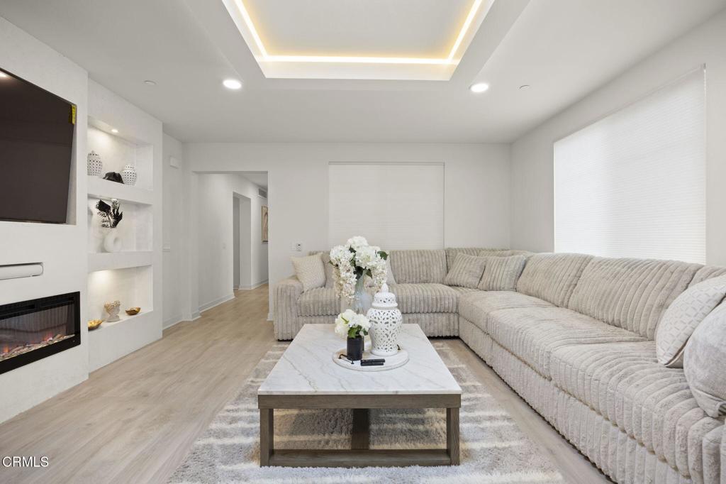 2850 Wagon Wheel Road, Unit 302 Oxnard, CA 93036 - Photo 7 of 50 a living room with furniture a fireplace and a flat screen tv