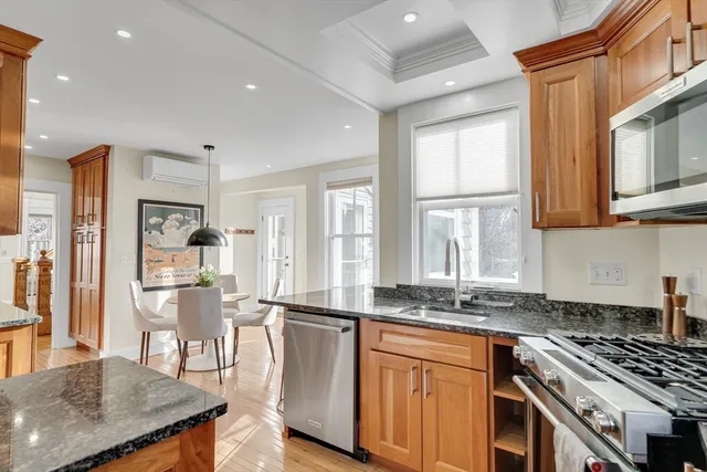 a kitchen with stainless steel appliances granite countertop a stove a sink and a refrigerator
