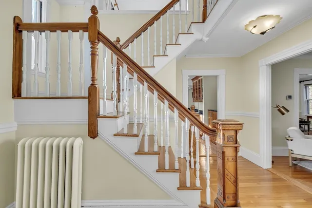 a view of entryway and hall with wooden floor