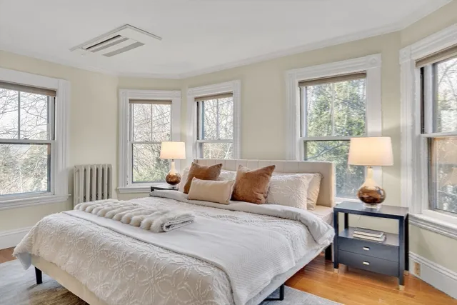 a bedroom with a bed and wooden floor