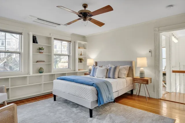 a spacious bedroom with a bed and a large window