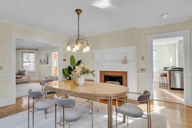 a view of a dining room with furniture and chandelier