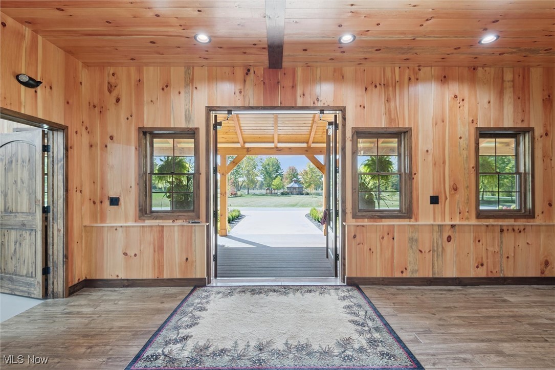 290 Townline Road Aurora, OH 44202 - Photo 6 of 50 Entryway featuring wood walls, wood finished floors, recessed lighting, and wood ceiling