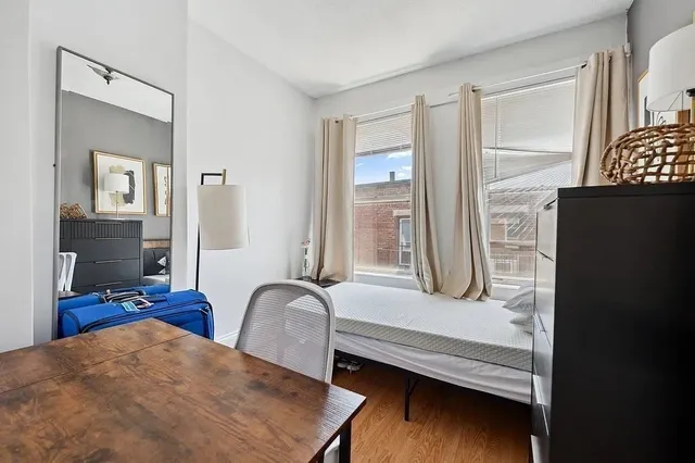 a view of bedroom with furniture and wooden floor