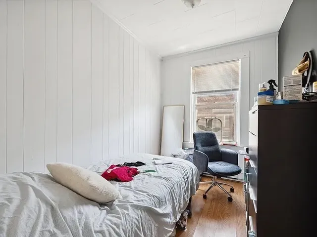 a bedroom with a bed and dresser