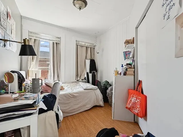 a bedroom with bed and window