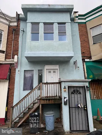 a view of a house with wooden deck