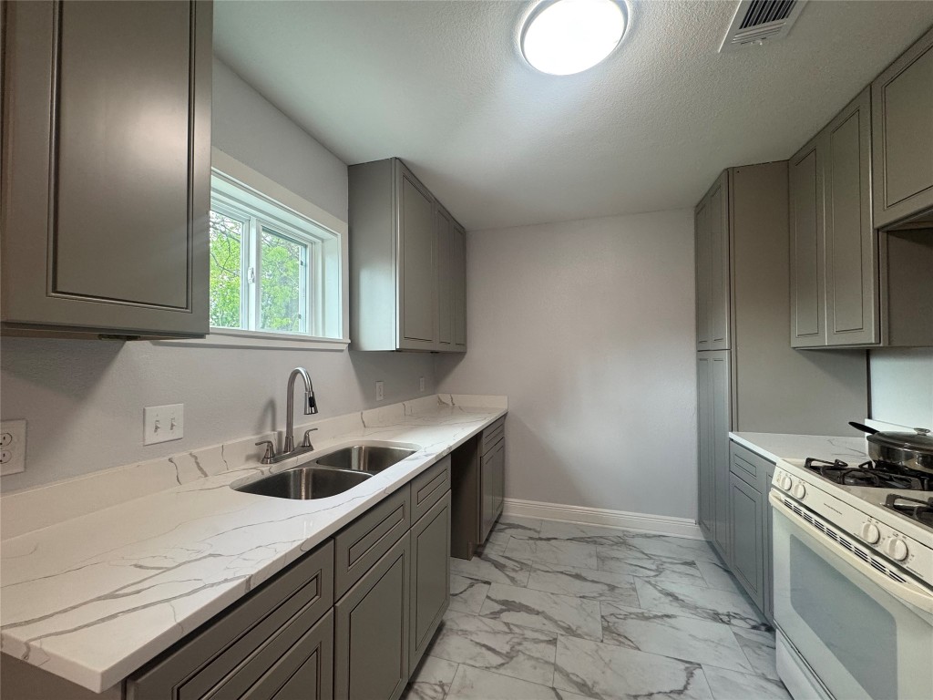 6645 Lodge Street Houston, TX 77092 - Photo 2 of 9 a kitchen that has a sink and a stove