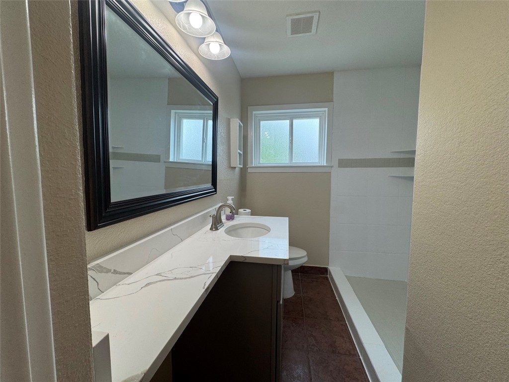 6645 Lodge Street Houston, TX 77092 - Photo 4 of 9 a bathroom with a sink and a mirror