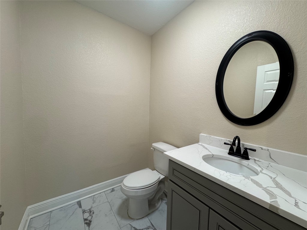 6645 Lodge Street Houston, TX 77092 - Photo 5 of 9 a bathroom with a sink a toilet and a mirror