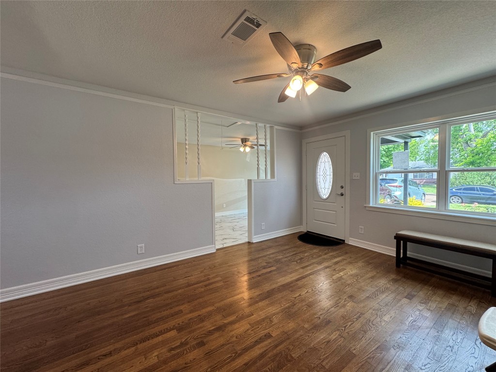 6645 Lodge Street Houston, TX 77092 - Photo 7 of 9 an empty room with wooden floor fan and windows