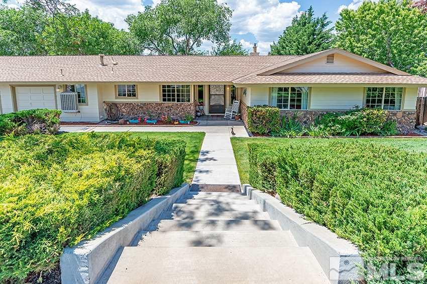 14405 Rancheros Drive Reno, NV 89521 - Photo 4 of 20 a front view of a house with a yard