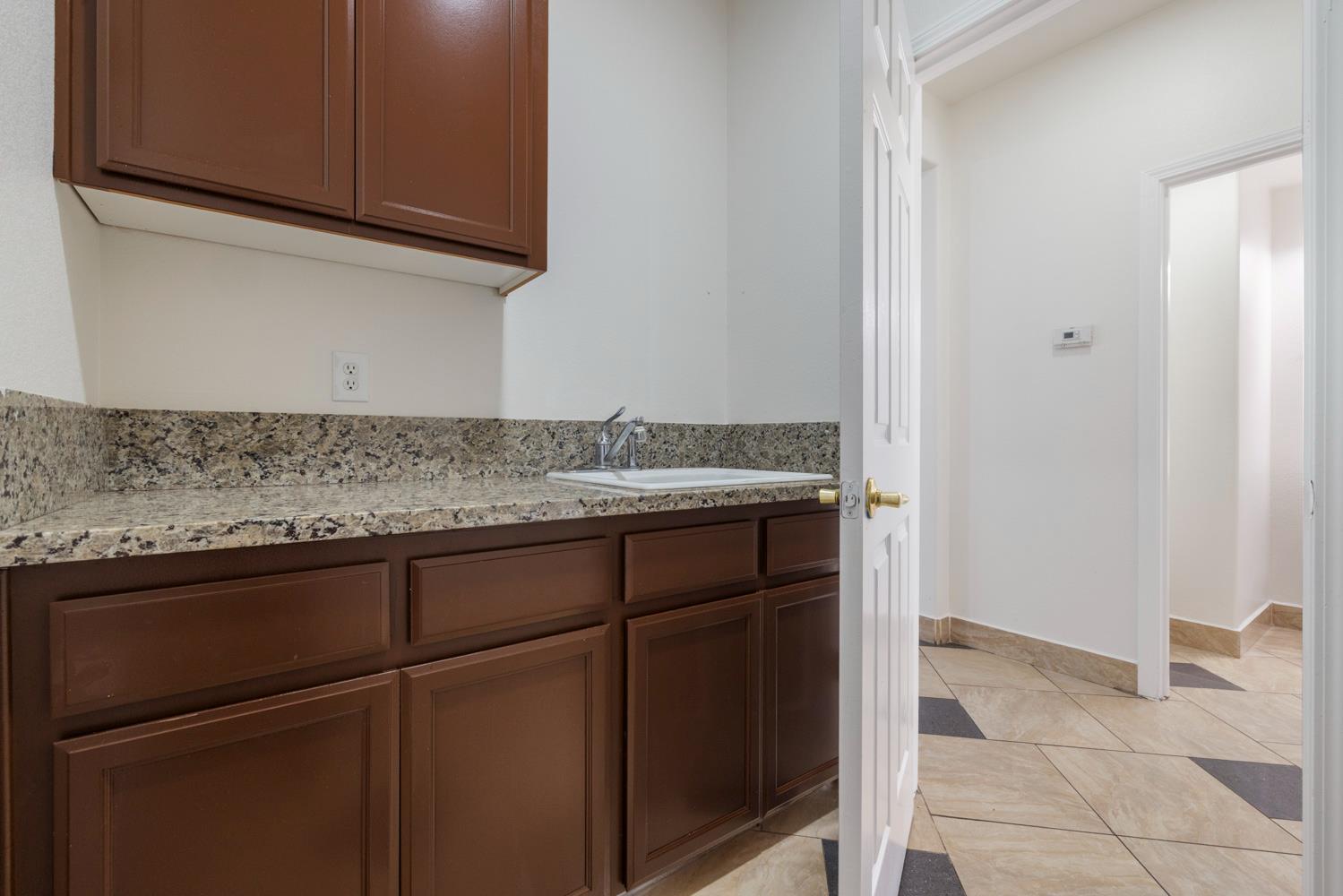 3105 Ripple Court Modesto, CA 95355 - Photo 19 of 46 a sink with granite top and cabinets