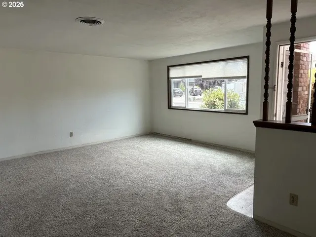 a kitchen with a refrigerator and a stove top oven