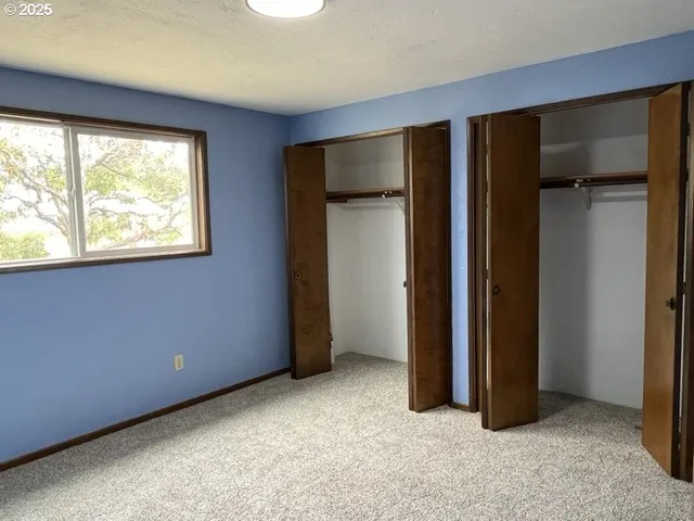 a view of an empty room with closet