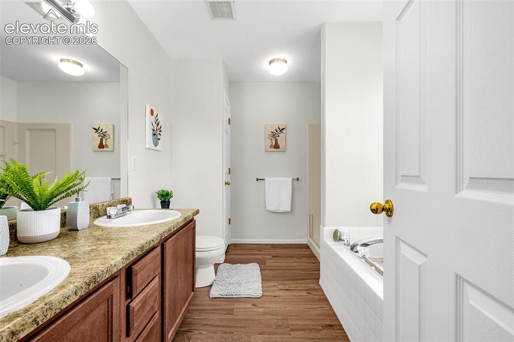 11185 Falling Star Road Fountain, CO 80817 - Photo 13 of 46 a bathroom with a granite countertop sink and a mirror