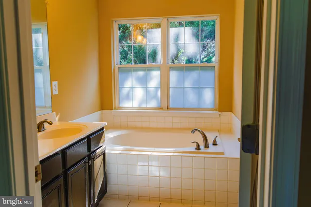 a bathroom with a bathtub and a window