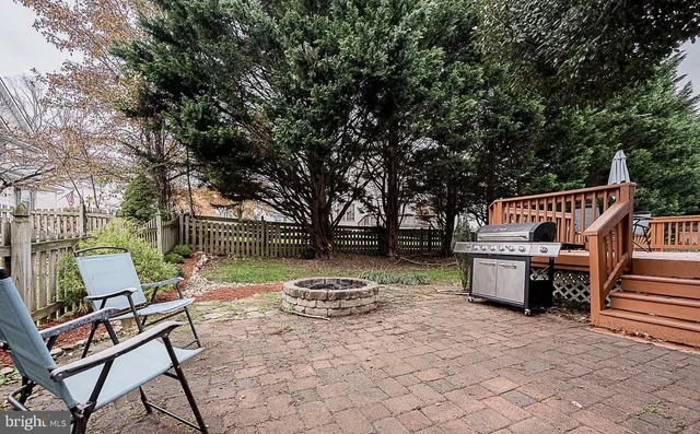 a view of backyard with deck and outdoor seating