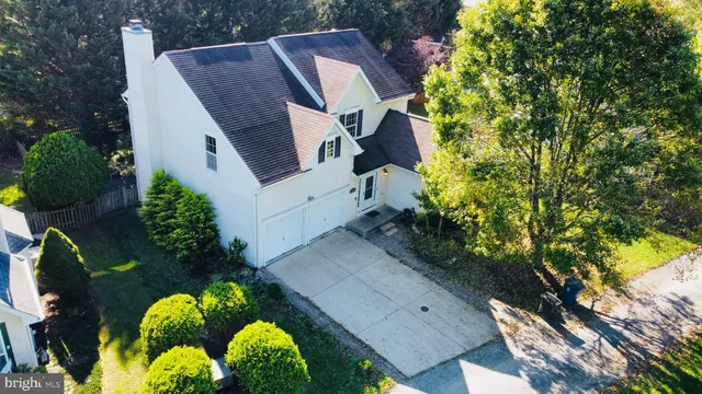 a aerial view of a house with large trees and plants