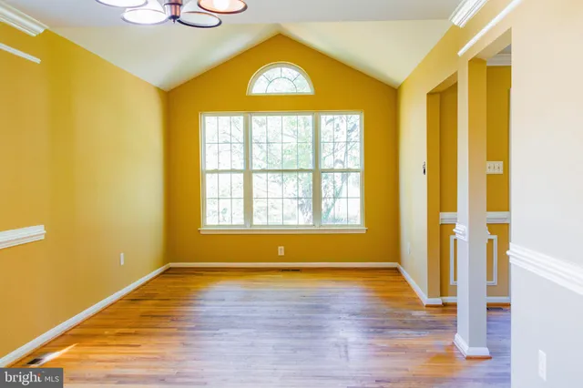 a view of livingroom with an entryway and wooden floor