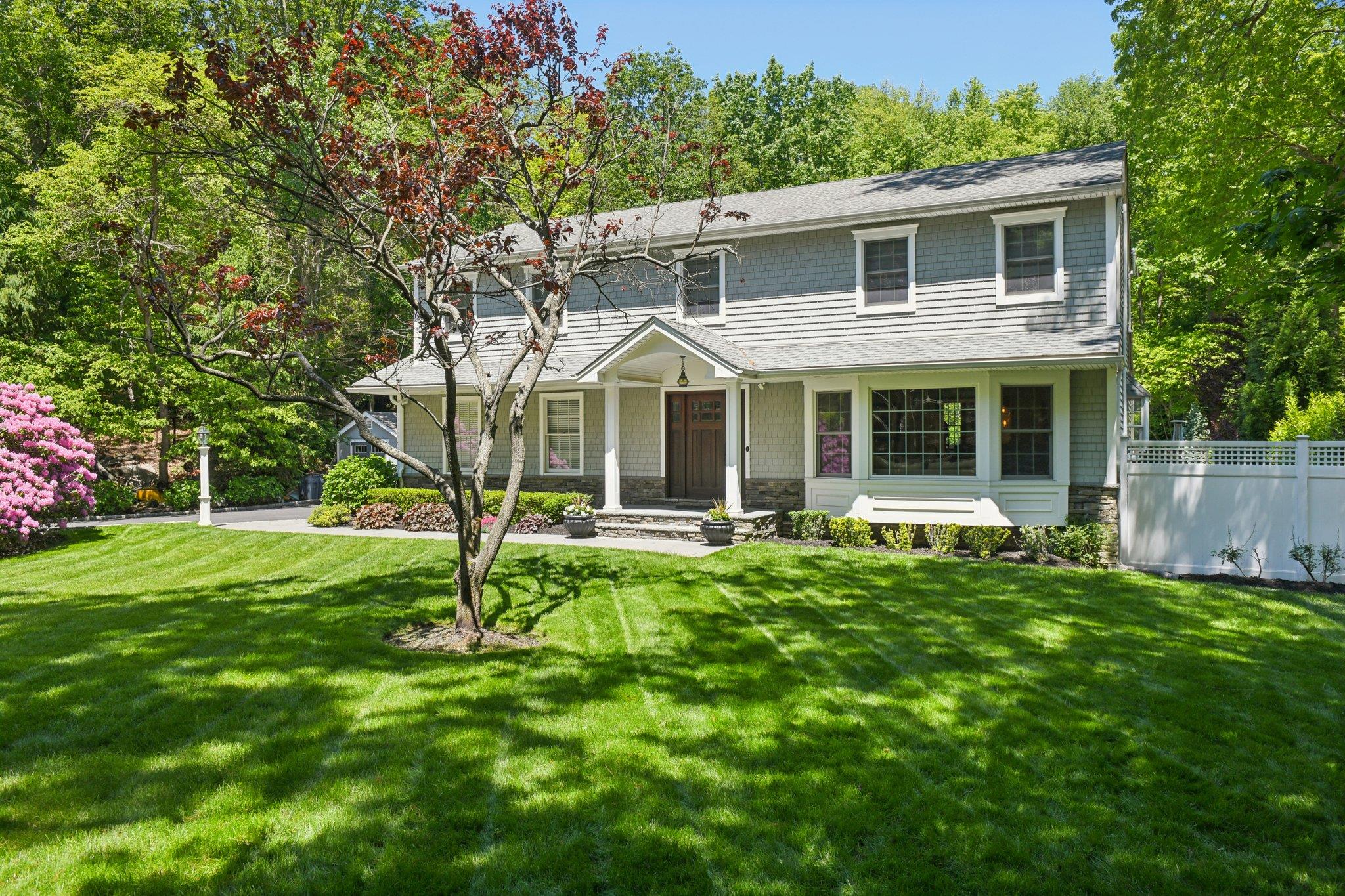 1 Highwoods Road St. James, NY 11780 - Photo 1 of 1 View of front facade featuring a porch, stone siding, and a shingled roof