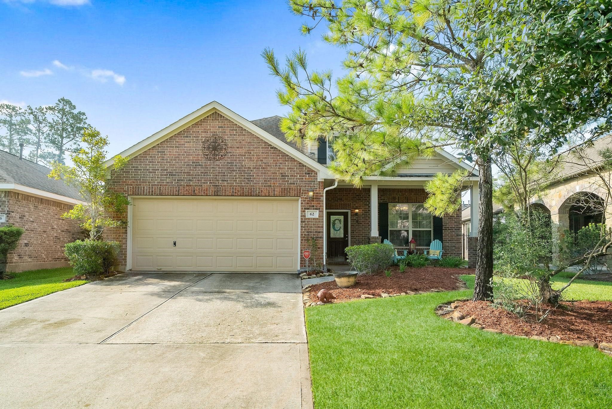 a view of a house with yard and tree s