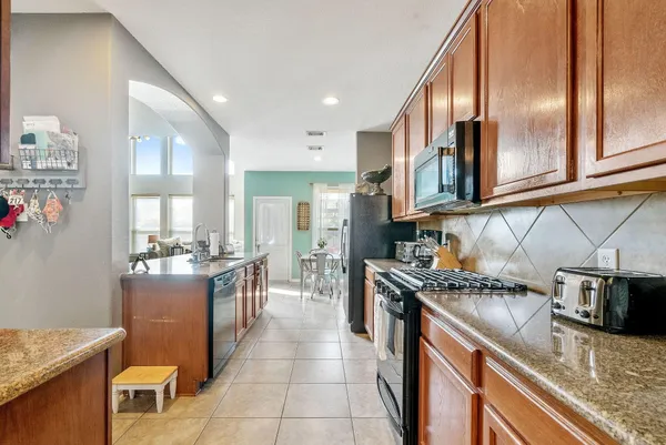 a kitchen with stainless steel appliances granite countertop a sink and cabinets