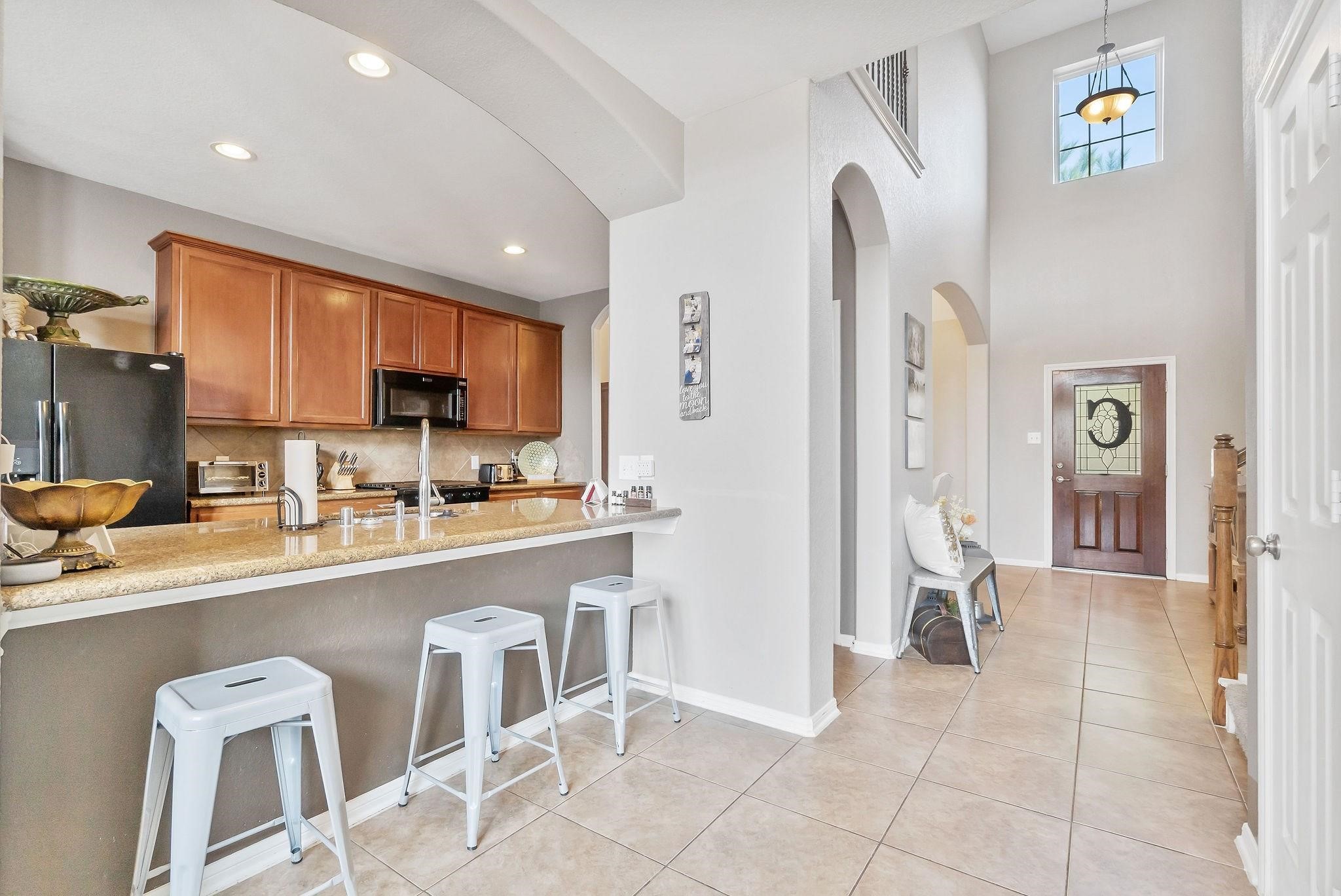 62 West Lasting Spring Circle The Woodlands, TX 77389 - Photo 21 of 46 a kitchen with stainless steel appliances granite countertop a refrigerator and a sink