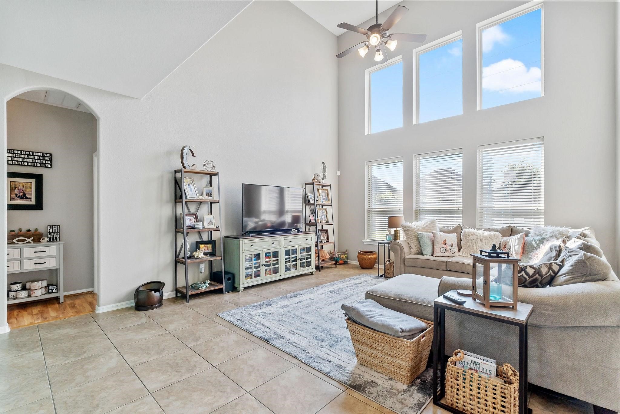 62 West Lasting Spring Circle The Woodlands, TX 77389 - Photo 22 of 46 a living room with furniture a chandelier and a flat screen tv