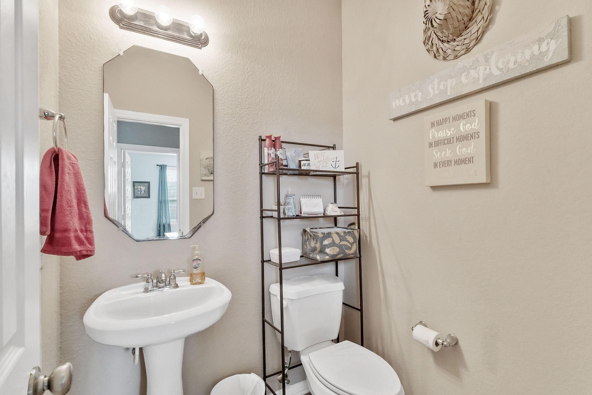 62 West Lasting Spring Circle The Woodlands, TX 77389 - Photo 26 of 46 a bathroom with a toilet sink and mirror
