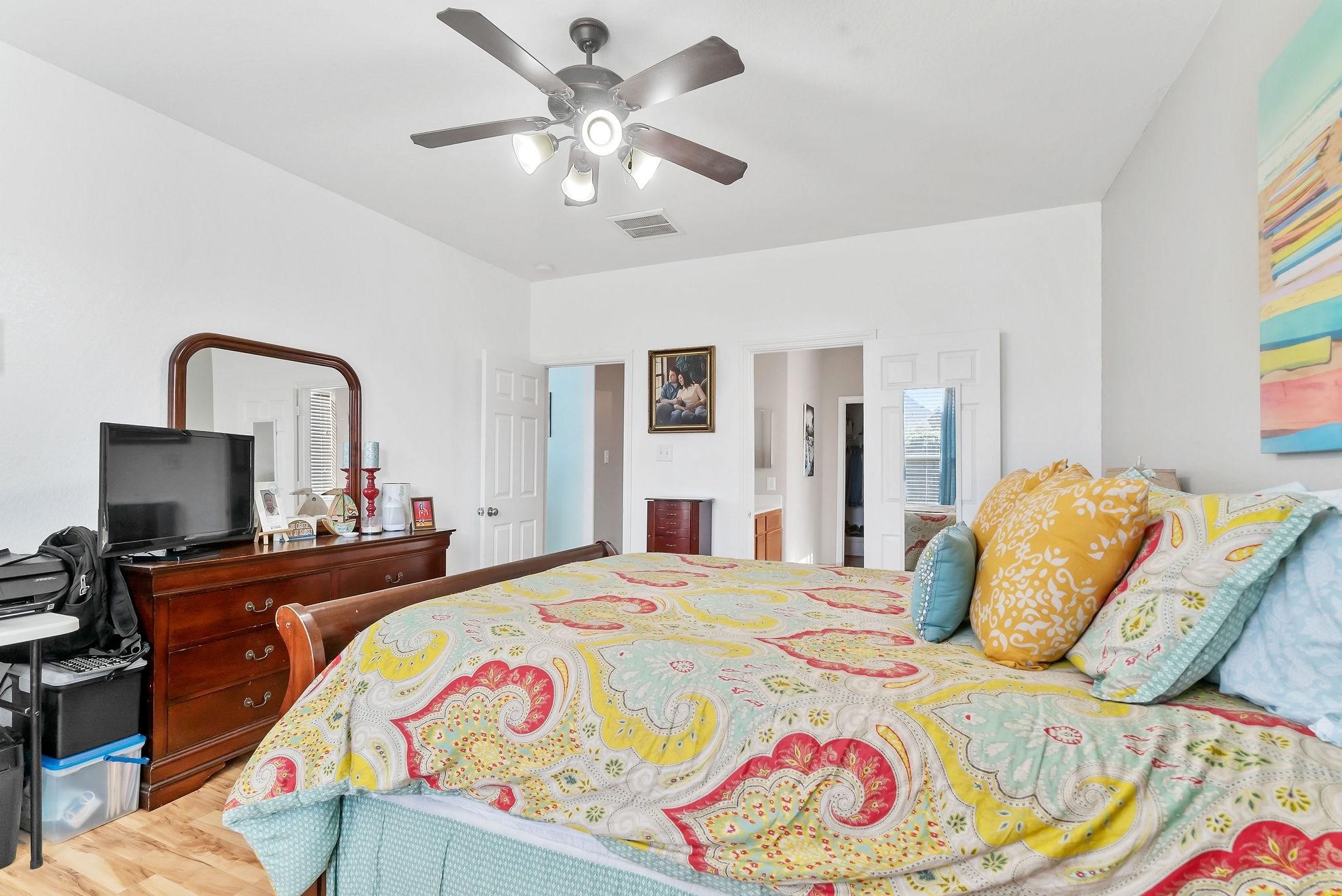 62 West Lasting Spring Circle The Woodlands, TX 77389 - Photo 28 of 46 a bedroom with a bed and a flat screen tv